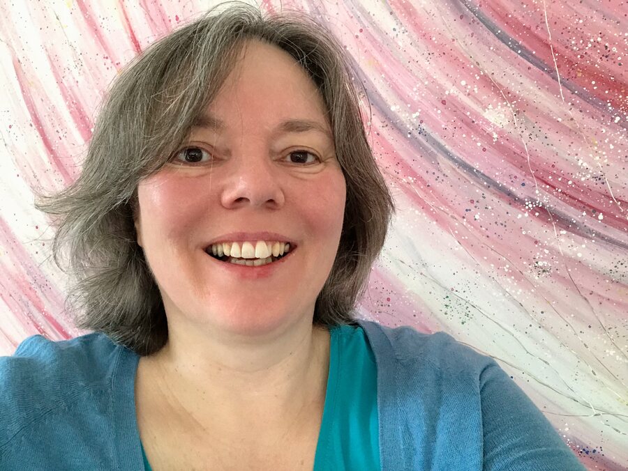 Carolyn Pini in front of one of her acrylic paintings