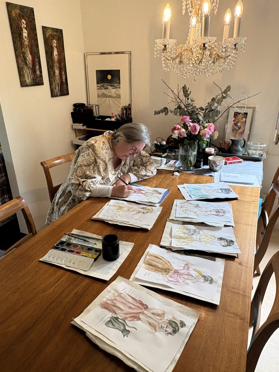 Carolyn Pini painting a watercolor in her studio